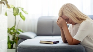 web3 woman pray home bible book shutterstock 1502671199