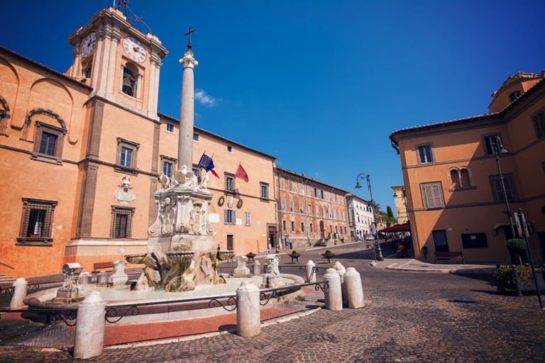 Fountain and town hall in the square of Tarquinia (Italy)