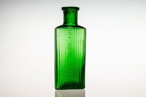 antique green glass bottle with a vertically ribbed body and not to be taken embossed vertically down the side m.png