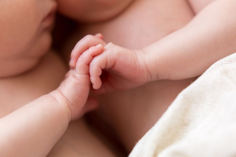 twin babies holding hands m.jpg