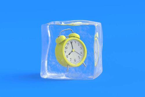 yellow alarm clock suspended in a cube of ice on a blue background m.png