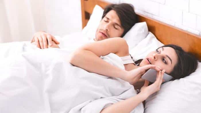 woman talking on phone in bed m.jpg