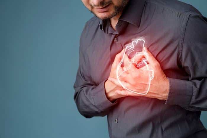 bearded person clutching their chest with both hands a glowing illustration of an anatomical heart superimposed over their hands m 1.jpg