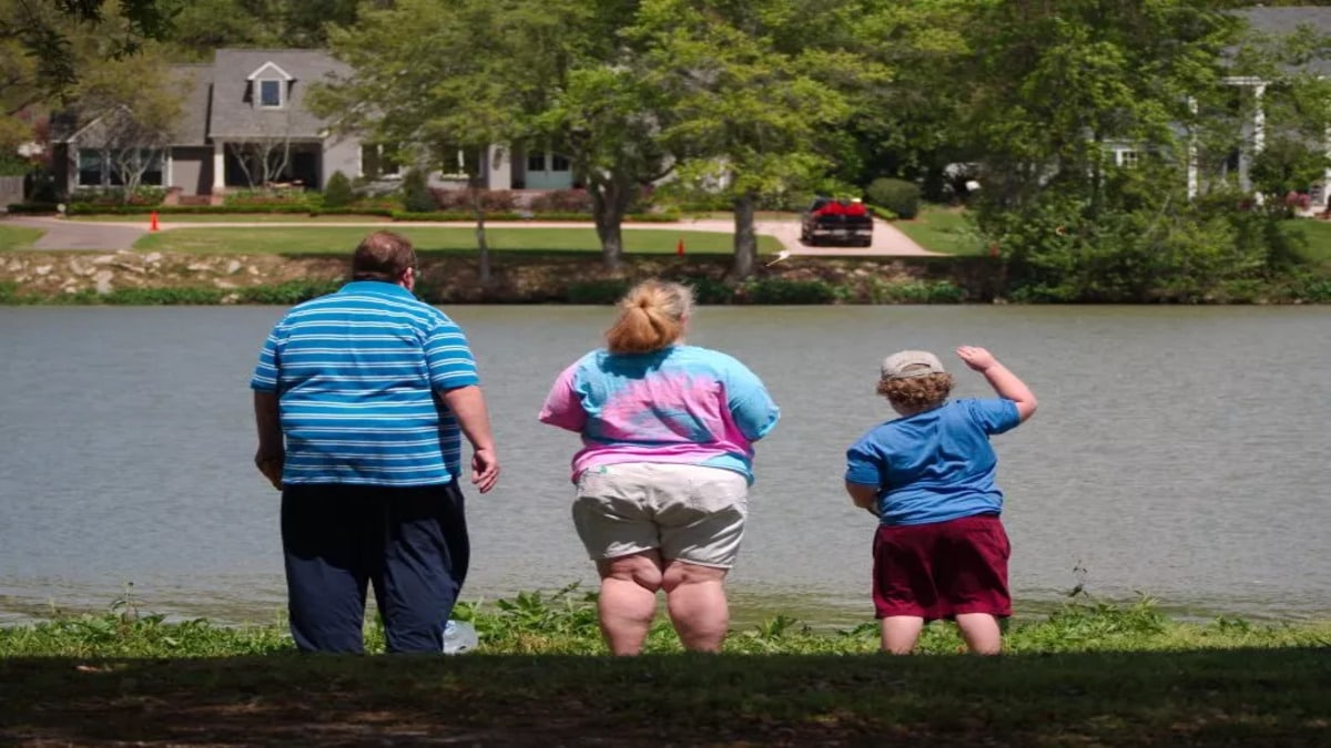 overweight family standing lake 1.jpg